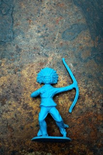 A vibrant blue plastic toy archer stands confidently, showcasing its detailed representation of an