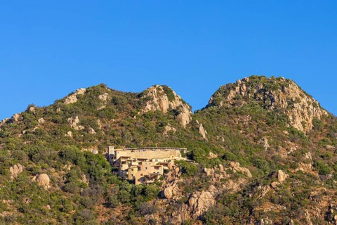 Small houses built into the steep, rocky slope characterise the landscape on the Costa Rei, a
