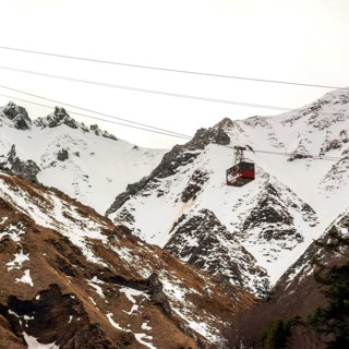 A gondola ascends the stunning Massif of Sancy, surrounded by a winter wonderland of snow-covered