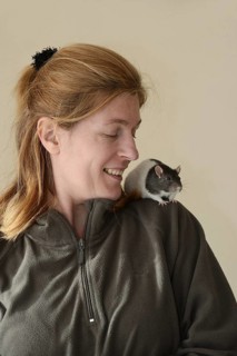 Woman with coloured rat (Rattus novegicus forma domestica) on her shoulder, North Rhine-Westphalia,