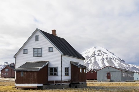 Wooden house in front of a mountain peak, Ny-Alesund, Spitsbergen, Svalbard