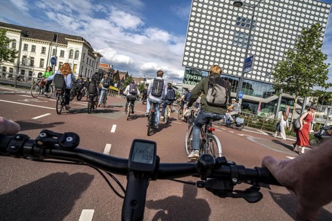 Ride your bike on the central cycle path on Lange Viestraat, Vredenburg, in the city centre of