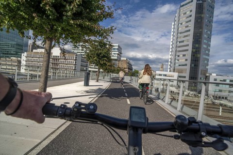 Cycling over the Moreelsebrug, pedestrian and cyclist bridge over the tracks of Utrecht Centraal,
