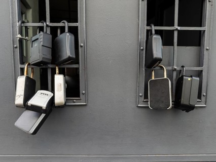 Key boxes on a grille of a basement window for flat flats in the city centre of Bratislava,