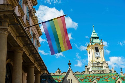 Rainbow flag on the Primatial Palace, in the background is the Old Town Hall of Bratislava,