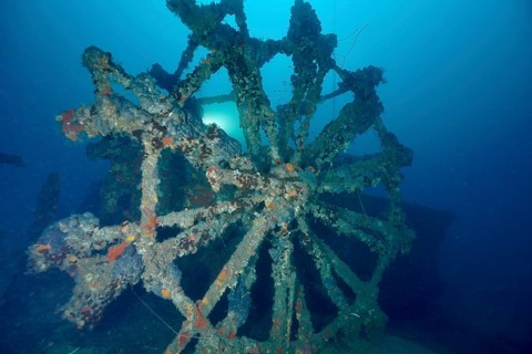 Dilapidated paddle wheel of a shipwreck in blue surroundings. Dive site wreck Ville de Grasse,