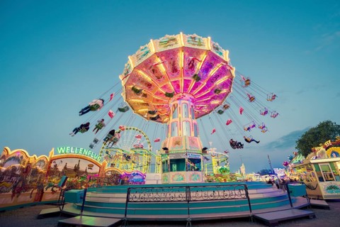 Radiant carousel under the night sky at a funfair, chain carousel, spring festival, Cannstatter