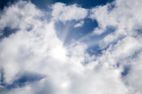Symbolic image, global warming, heat, the sun shines through partly overcast clouds and illuminates