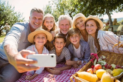 Cheerful happy family taking selfie on picnic on a family vacation day, AI generated