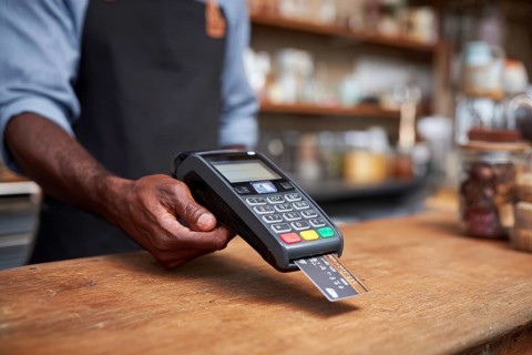 Businessman using payment terminal, credit card is inserted in POS to complete digital payment, AI