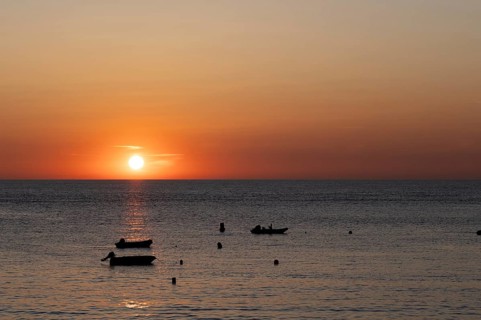 Boats in front of sunset at the sea, North Sea, English Channel, Étretat, evening mood,
