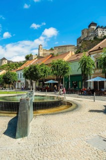 Mark Aurel fountain and fountain on Peace Square with Trencin Castle in the background, Capital of