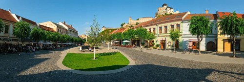 Peace Square with cafés in the old town centre of Trencin, Trencin Castle in the background,