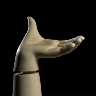 A detailed view of a mannequin hand with fingers slightly curled, creating a graceful pose against