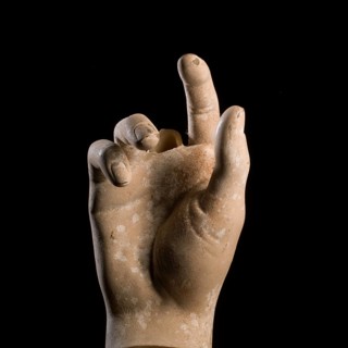A sculpted hand gesture captures attention with its realistic depiction. The focus is on the