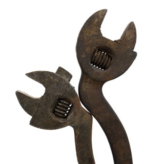 This close-up showcases a rusty adjustable spanner displaying signs of extensive use and age. The