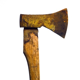 A rusty axel stands prominently against a simple backdrop, showcasing its worn texture and