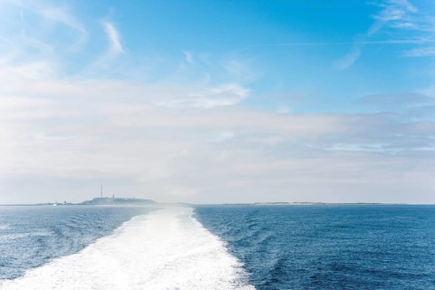 Wide boat track, water track, foam track leading towards the islands of Heligoland (main island and