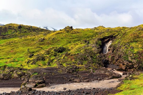 Barren moss-covered volcanic landscape, stream, Arnarstapi, Snaefellsjökull volcanic system,