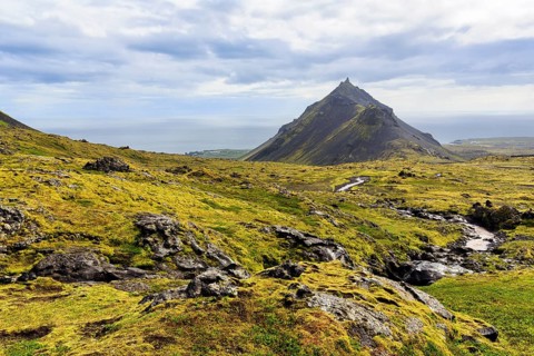 Barren moss-covered volcanic landscape, cone-shaped mountain Stapafell, Arnarstapi, Snæfellsjökull