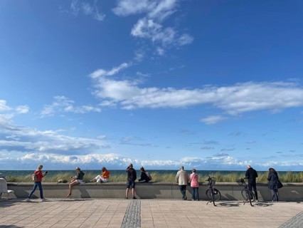 People on the beach promenade looking out to sea, blue sky, Baltic resort Kühlungsborn, Baltic Sea,