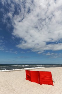 Lonely beach with red windbreak, blue sky, Baltic Sea near Kühlungsborn, Mecklenburg-Western