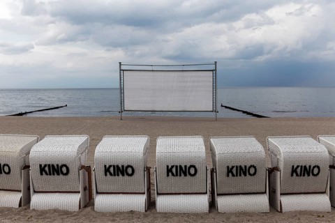 Kühlungsborn beach cinema, cinema screen and beach chairs for cinema-goers, cloudy sky, Baltic Sea,