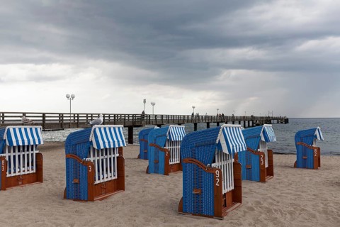 Pier and beach with closed beach chairs, rain clouds, Kühlungsborn, Baltic Sea, Mecklenburg-Western