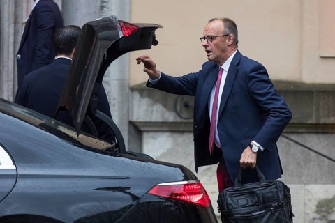 Friedrich Merz (CDU, German Chancellor) takes something out of a car boot in front of the joint