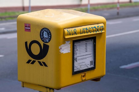 Deutsche Post letterbox, with stickers and graffiti, labelled Only love letters, Leverkusen, North