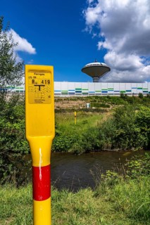 Marker post for a long-distance gas pipeline on the river Dhünn, 40 km long river that flows into