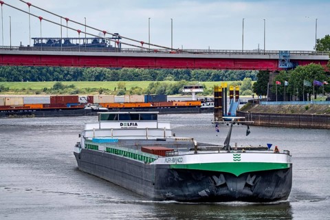Barge enters the Vinckekanal, in the harbour of Ruhrort, container freighter on the Rhine, on an