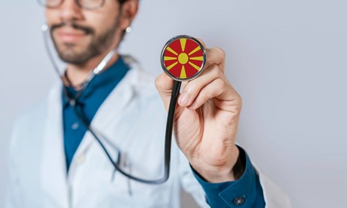 Doctor holding stethoscope with North Macedonia flag. North Macedonia health and care concept,