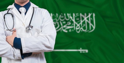 Male doctor with stethoscope on Saudi Arabia flag. Doctor holding stethoscope on Saudi Arabia flag