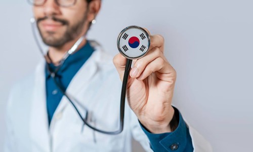 Doctor holding stethoscope with South Korea flag. South Korea health and care concept, South Korea