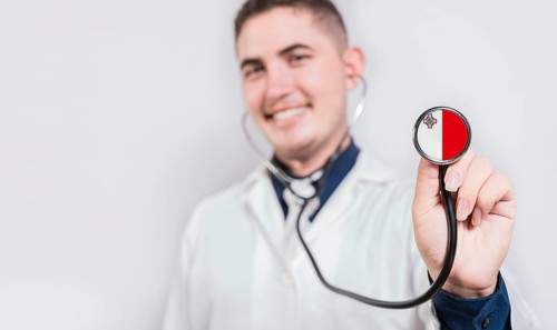 Doctor showing stethoscope with Malta flag. Malta national healthcare concept