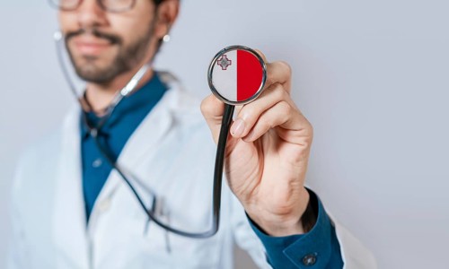 Doctor holding stethoscope with Malta flag. Malta health and care concept, Malta flag on