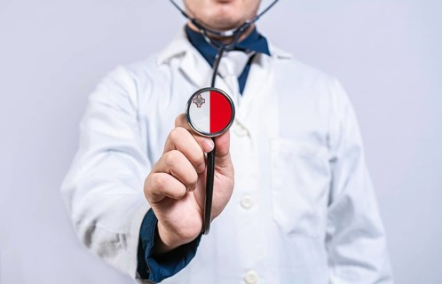 Doctor hands holding stethoscope with Malta flag. Malta health and care concept