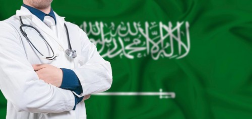 Saudi Arabia healthcare concept. Male doctor on Saudi Arabia flag. Doctor with crossed arms on