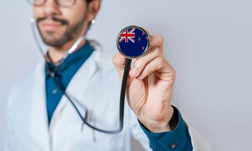 Doctor holding stethoscope with New Zealand flag. New Zealand health and care concept, New Zealand