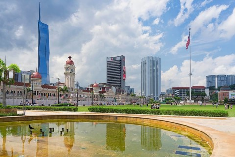 Skyscrapers reflecting in Merdeka square pond, Kuala Lumpur, Malaysia, Asia