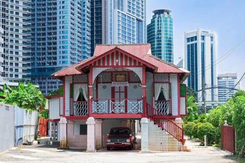 Traditional small house surrounded by modern skyscrapers, Kuala Lumpur, Malaysia, Asia