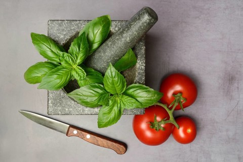 Basil in mortar and tomato, Ocimum basilicum, Solanum lycopersicum