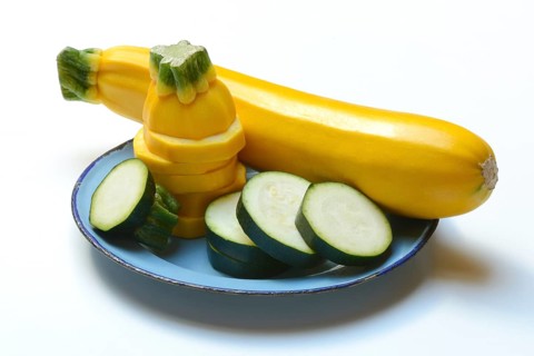 Green and yellow courgettes on a plate, Cucurbita pepo