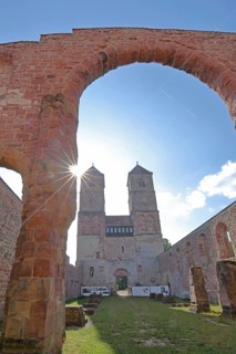 Romanesque St. Mary's Collegiate Church backlit with archway, twin towers, church ruins, interior