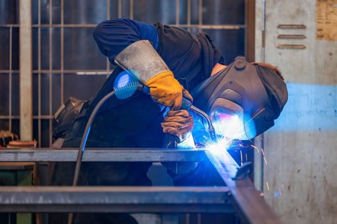 Germany - Theme photo metal industry. An industrial welder welds a workpiece