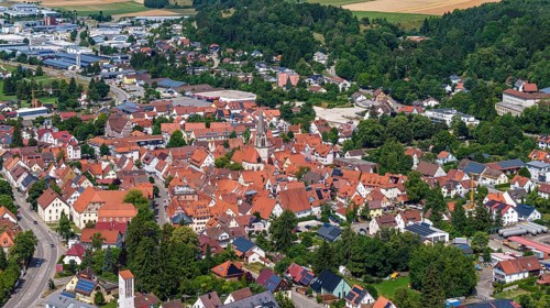 Town view of Münsingen on the Swabian Alb with town hall and church. Drone photo. Town centre of