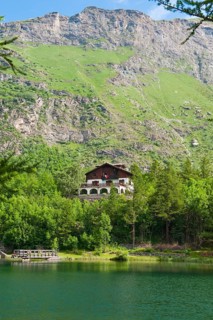 View of chalet at mountain lake Lago Grande near Moncenisio in Val Cenischia in Graian Alps,