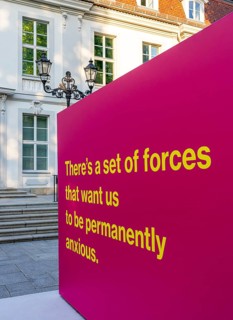 Tony Cokes, visual artist and educator, display panel at the Palais Populaire Unter den Linden,
