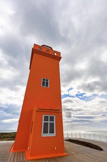 Orange lighthouse Skálasnagaviti or Svörtuloft with wooden boardwalk, Skalasnagi, Öndverdarnes,